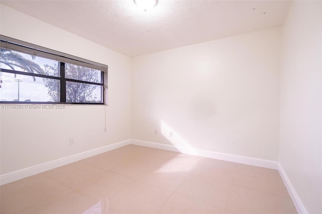 28451 SW 164th Ave, Homestead, FL 33033 - empty room with a textured ceiling and baseboards