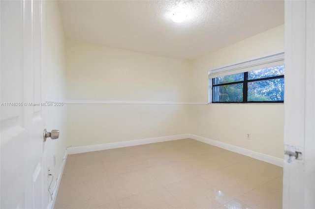 28451 SW 164th Ave, Homestead, FL 33033 - empty room with a textured ceiling and baseboards