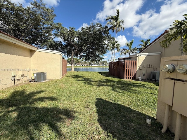 view of yard featuring a water view and central air condition unit