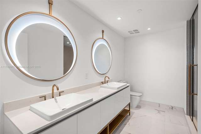 full bathroom featuring marble finish floor, a sink, toilet, and recessed lighting