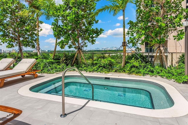 view of swimming pool featuring a patio area and fence