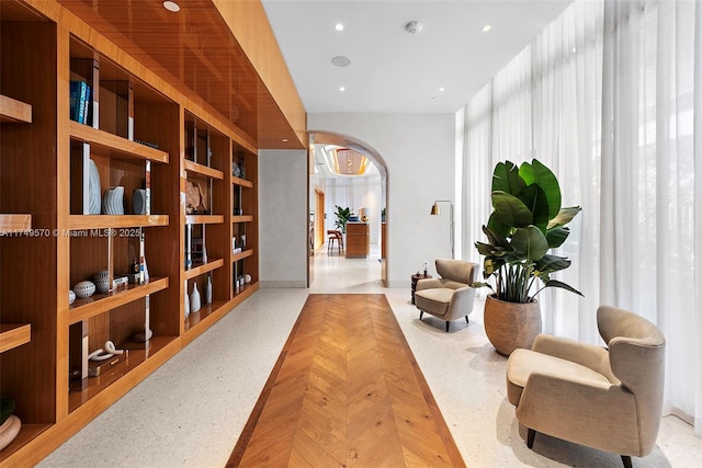 living area with arched walkways and recessed lighting