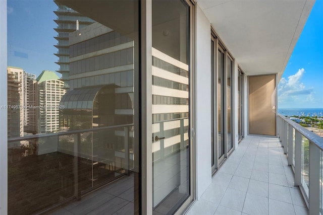 balcony featuring a view of city and a water view