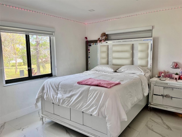 bedroom with marble finish floor and baseboards