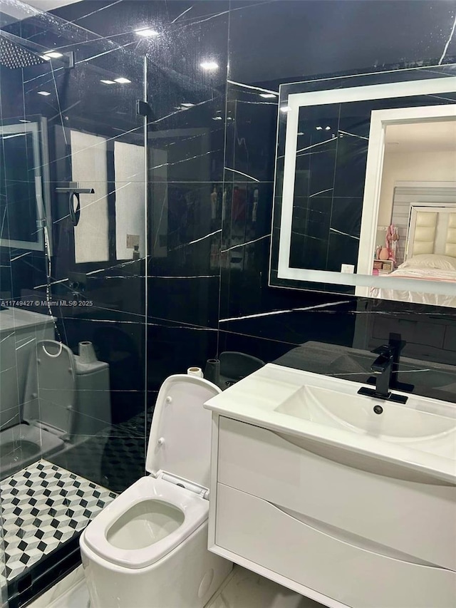 bathroom featuring a shower stall, tile walls, toilet, and vanity