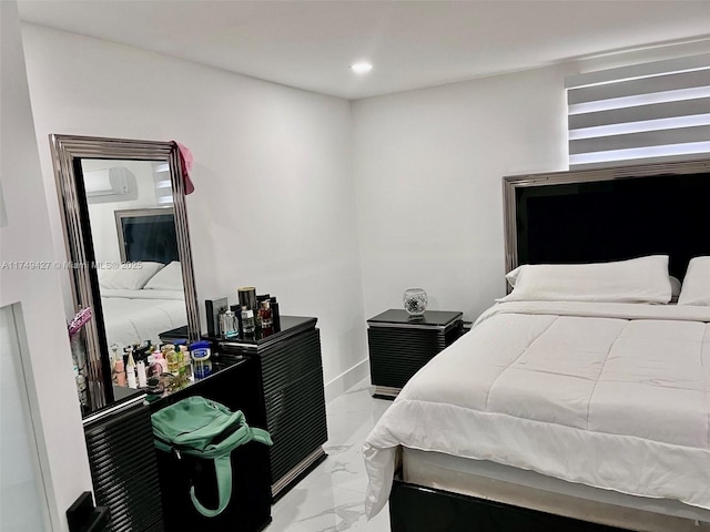 bedroom featuring recessed lighting, marble finish floor, and baseboards