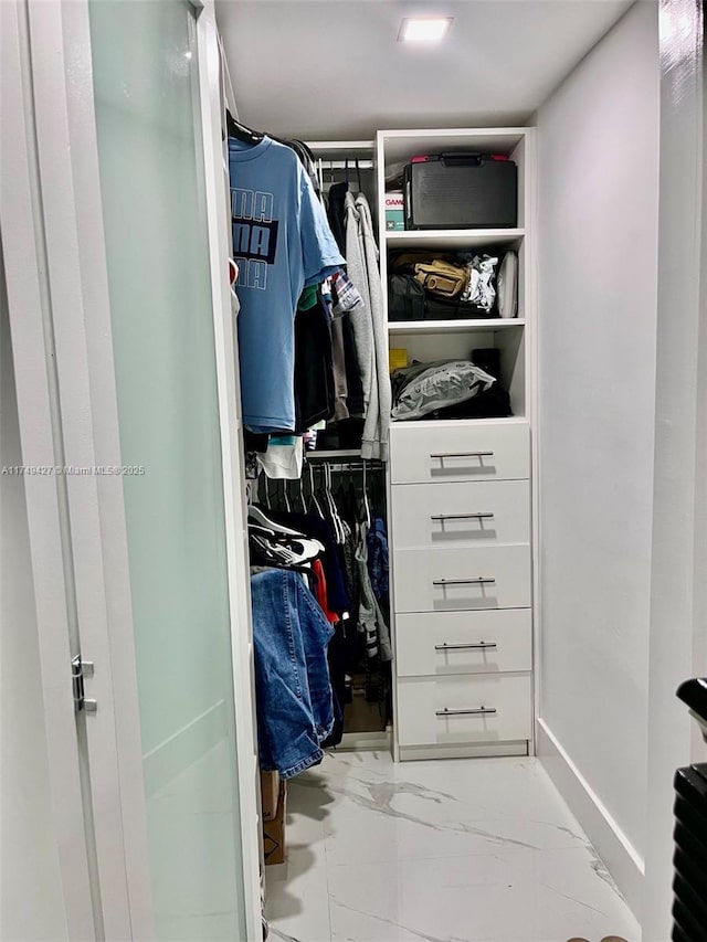 spacious closet with marble finish floor