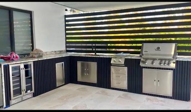 bar featuring wine cooler and a sink