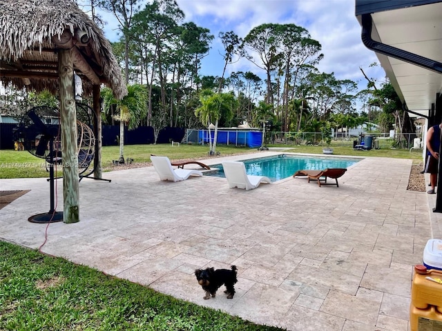 view of pool with a patio, fence, and a fenced in pool