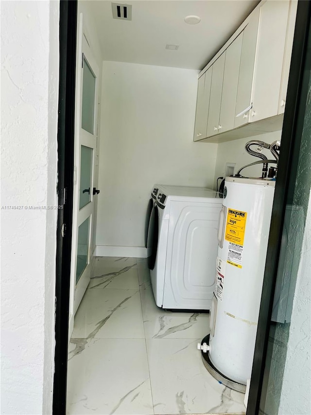 clothes washing area with electric water heater, visible vents, marble finish floor, cabinet space, and washer / clothes dryer