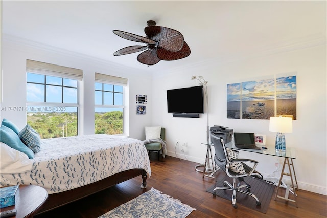 bedroom with ornamental molding and dark wood-style floors