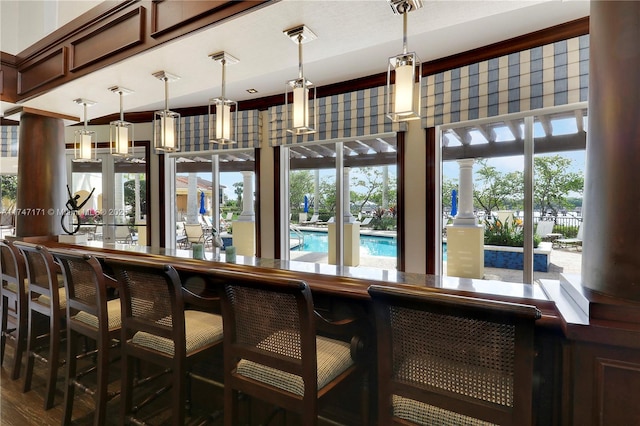 bar featuring visible vents, a dry bar, and decorative light fixtures