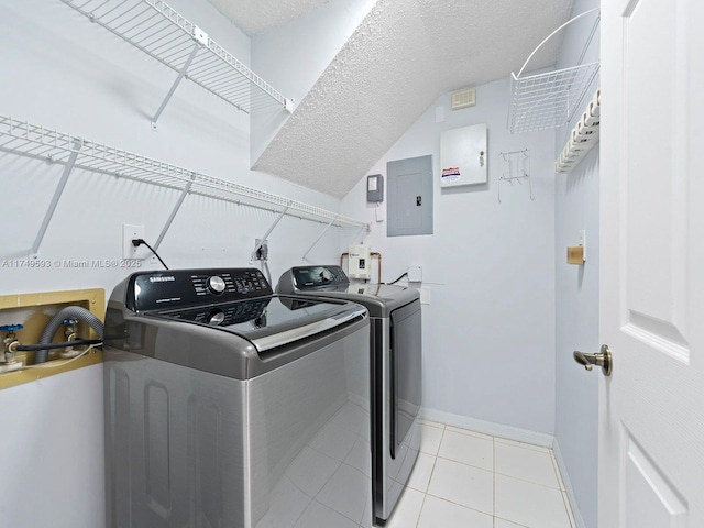 washroom with a textured ceiling, laundry area, electric panel, independent washer and dryer, and baseboards