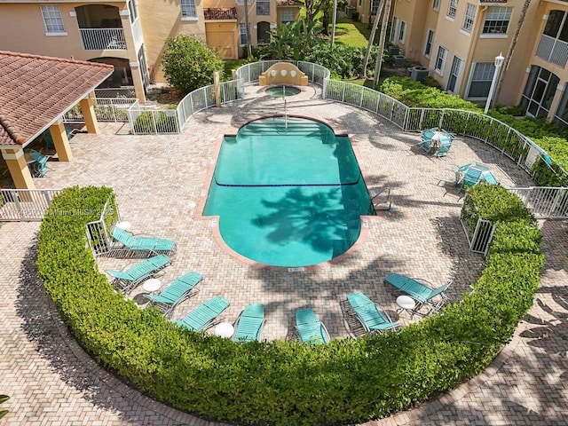 view of swimming pool with fence, central AC, and a patio