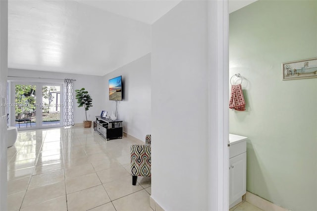 hallway featuring french doors and light tile patterned flooring