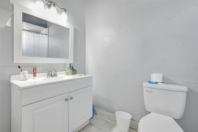 full bath with baseboards, vanity, toilet, and tile patterned floors