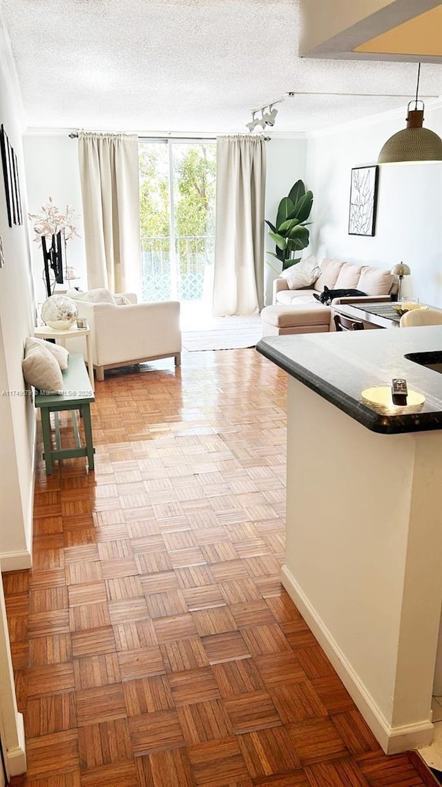 interior space with a textured ceiling and baseboards