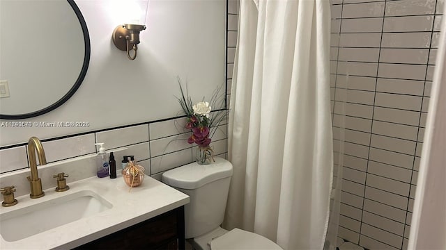 full bathroom with toilet, vanity, tile walls, tasteful backsplash, and a stall shower