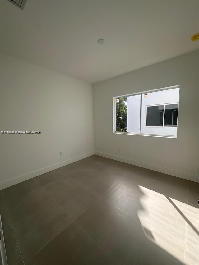 empty room featuring baseboards