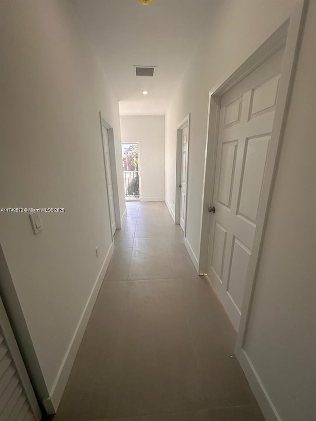 corridor featuring visible vents and baseboards