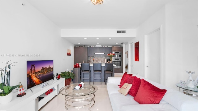 living area featuring visible vents and recessed lighting