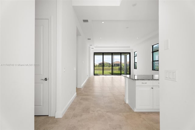 corridor featuring visible vents, recessed lighting, and baseboards