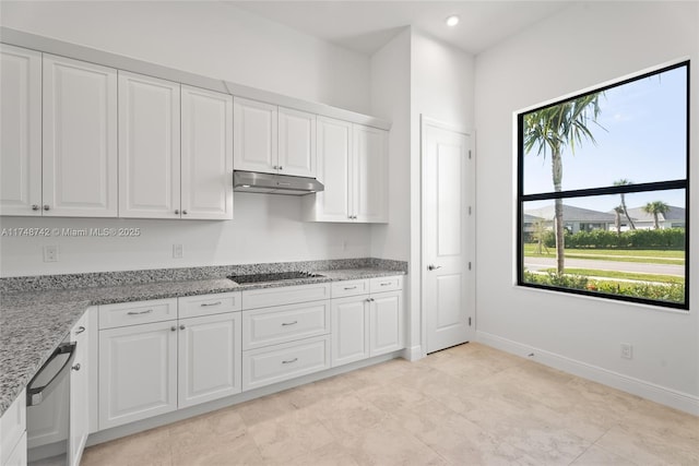 kitchen featuring a wealth of natural light, black electric cooktop, white cabinets, and under cabinet range hood