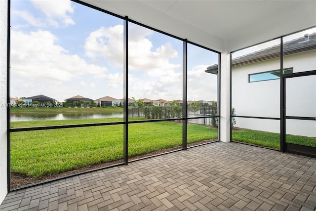 unfurnished sunroom with a water view
