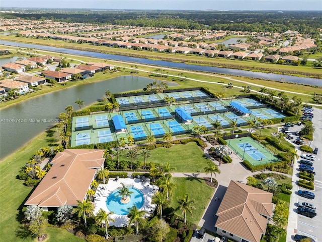 drone / aerial view featuring a residential view and a water view