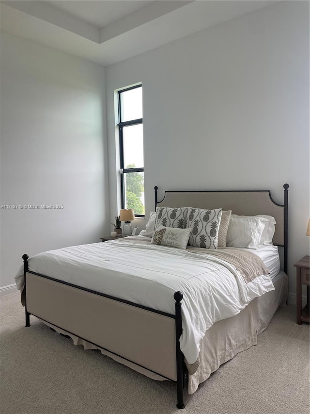 carpeted bedroom with baseboards