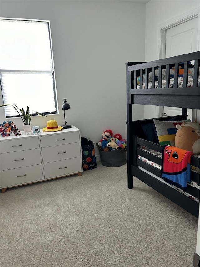 bedroom featuring light carpet