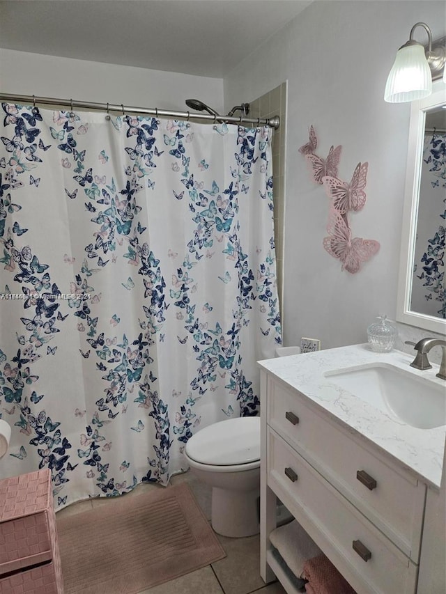 bathroom featuring toilet, tile patterned floors, a shower with curtain, and vanity