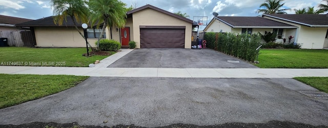 ranch-style house featuring a garage, driveway, a front lawn, and stucco siding