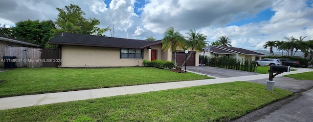 ranch-style house featuring aphalt driveway, a garage, fence, stucco siding, and a front yard