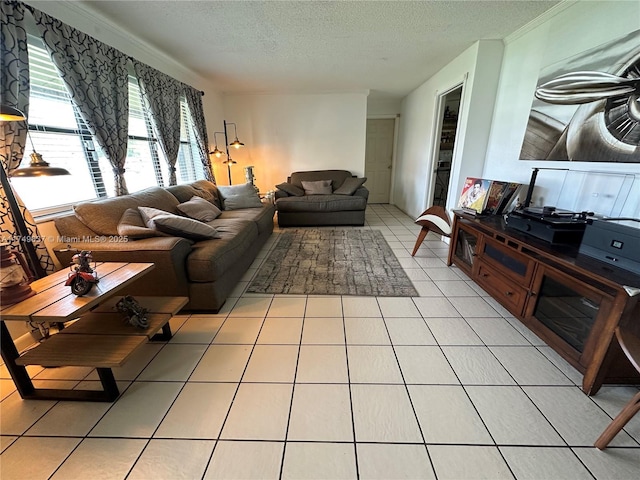 living area featuring light tile patterned floors, a textured ceiling, and crown molding