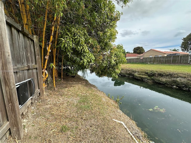 property view of water featuring fence