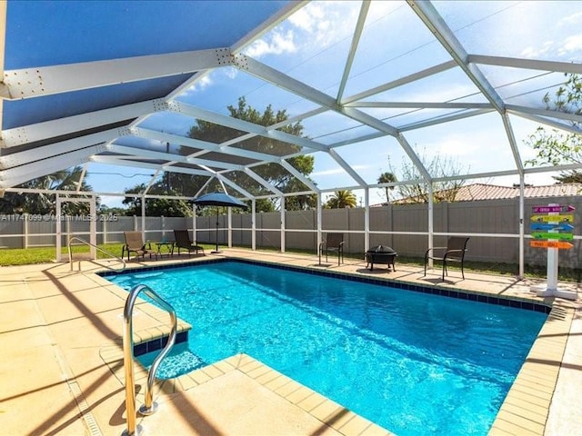 view of swimming pool featuring a fenced in pool, a fenced backyard, glass enclosure, and a patio area