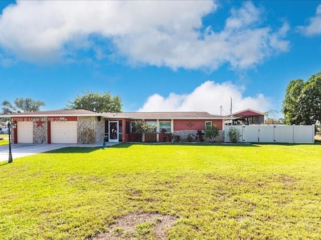 single story home with concrete driveway, an attached garage, fence, and a front yard