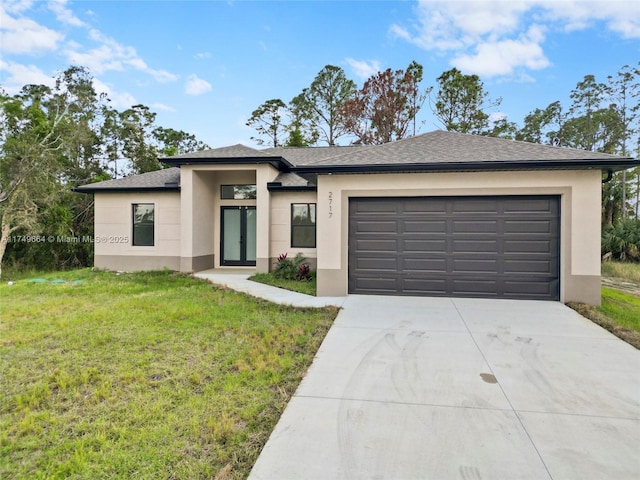 prairie-style home featuring driveway, a shingled roof, an attached garage, a front yard, and stucco siding