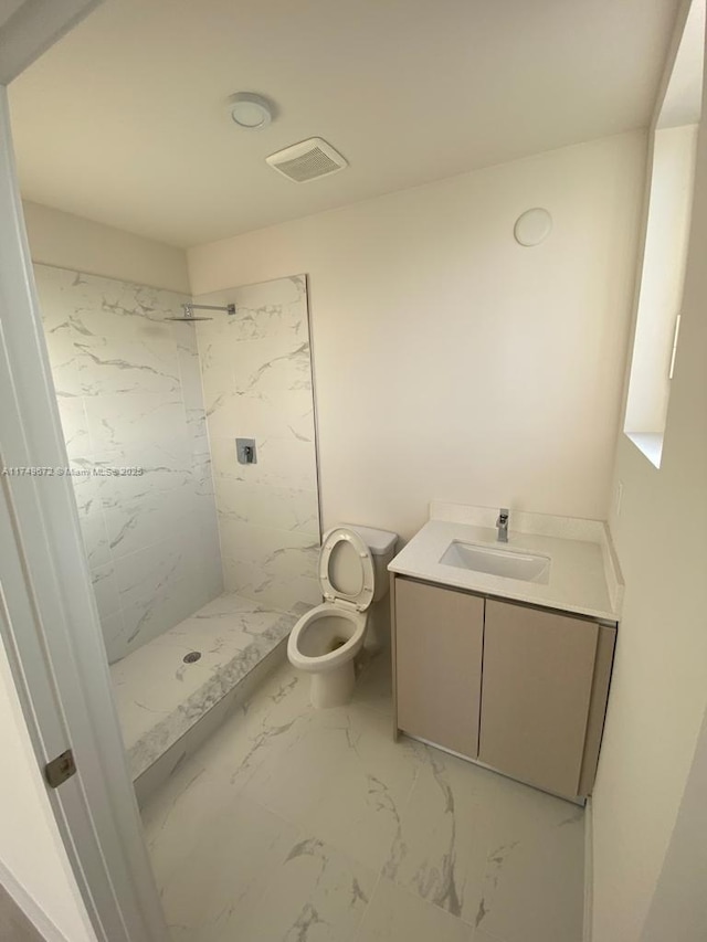 2561 NE 193rd St Unit 1202, Miami, FL 33180 - bathroom with a marble finish shower, visible vents, toilet, marble finish floor, and vanity