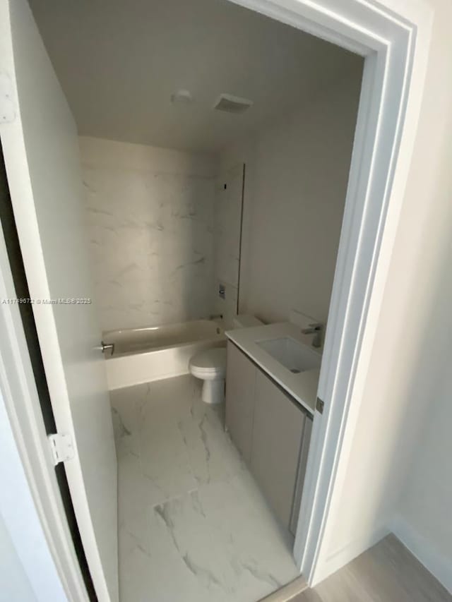 2561 NE 193rd St Unit 1202, Miami, FL 33180 - bathroom with marble finish floor, vanity, bathtub / shower combination, and toilet