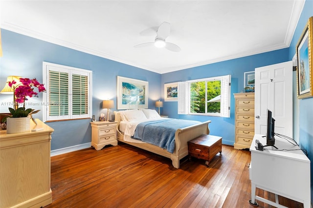 bedroom featuring dark wood-type flooring, ornamental molding, baseboards, and a ceiling fan