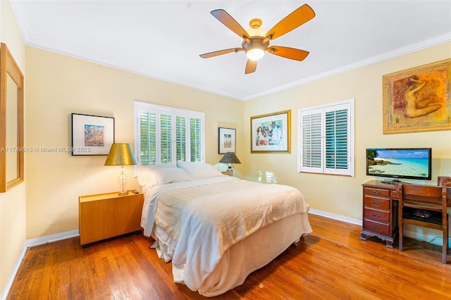 bedroom featuring ornamental molding and wood finished floors