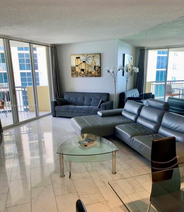 living area featuring a textured ceiling, plenty of natural light, and floor to ceiling windows