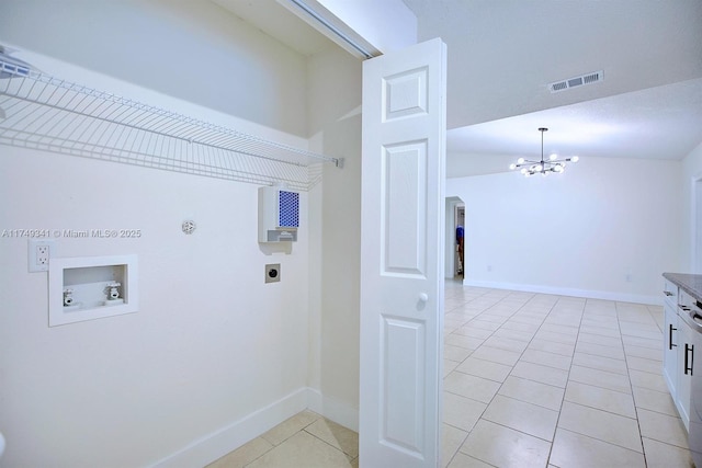 clothes washing area with laundry area, visible vents, hookup for a washing machine, hookup for an electric dryer, and light tile patterned flooring