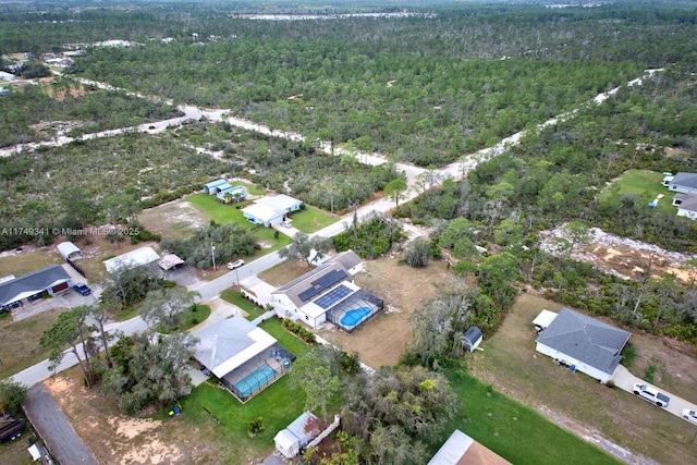 birds eye view of property featuring a forest view