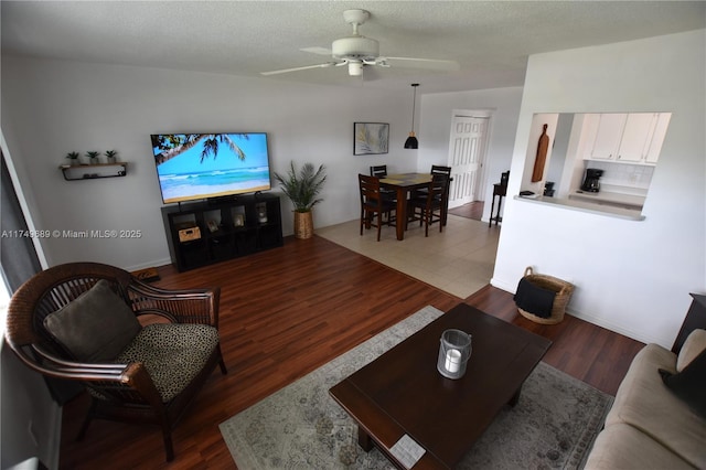 67 Berkshire Unit 67-C, West Palm Beach, FL 33417 - living area with a ceiling fan, wood finished floors, and baseboards