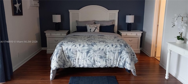 bedroom with dark wood-style flooring and baseboards