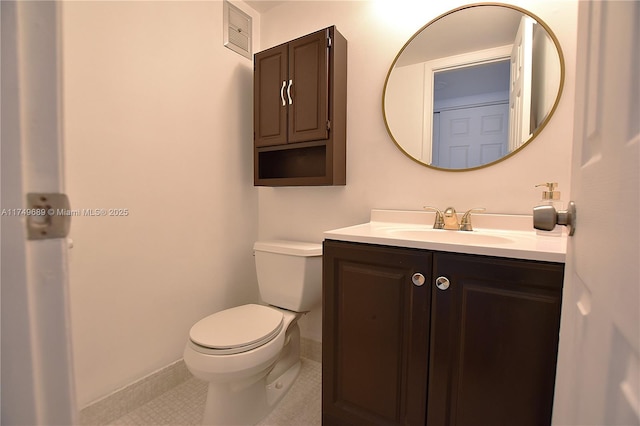 67 Berkshire Unit 67-C, West Palm Beach, FL 33417 - half bath with vanity, toilet, tile patterned floors, and baseboards