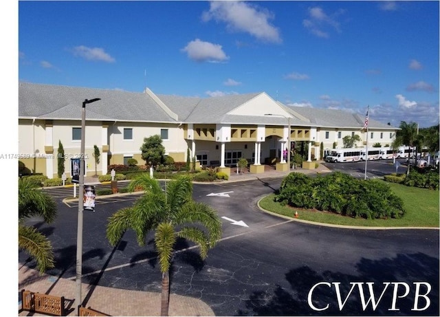 view of property featuring uncovered parking and a residential view